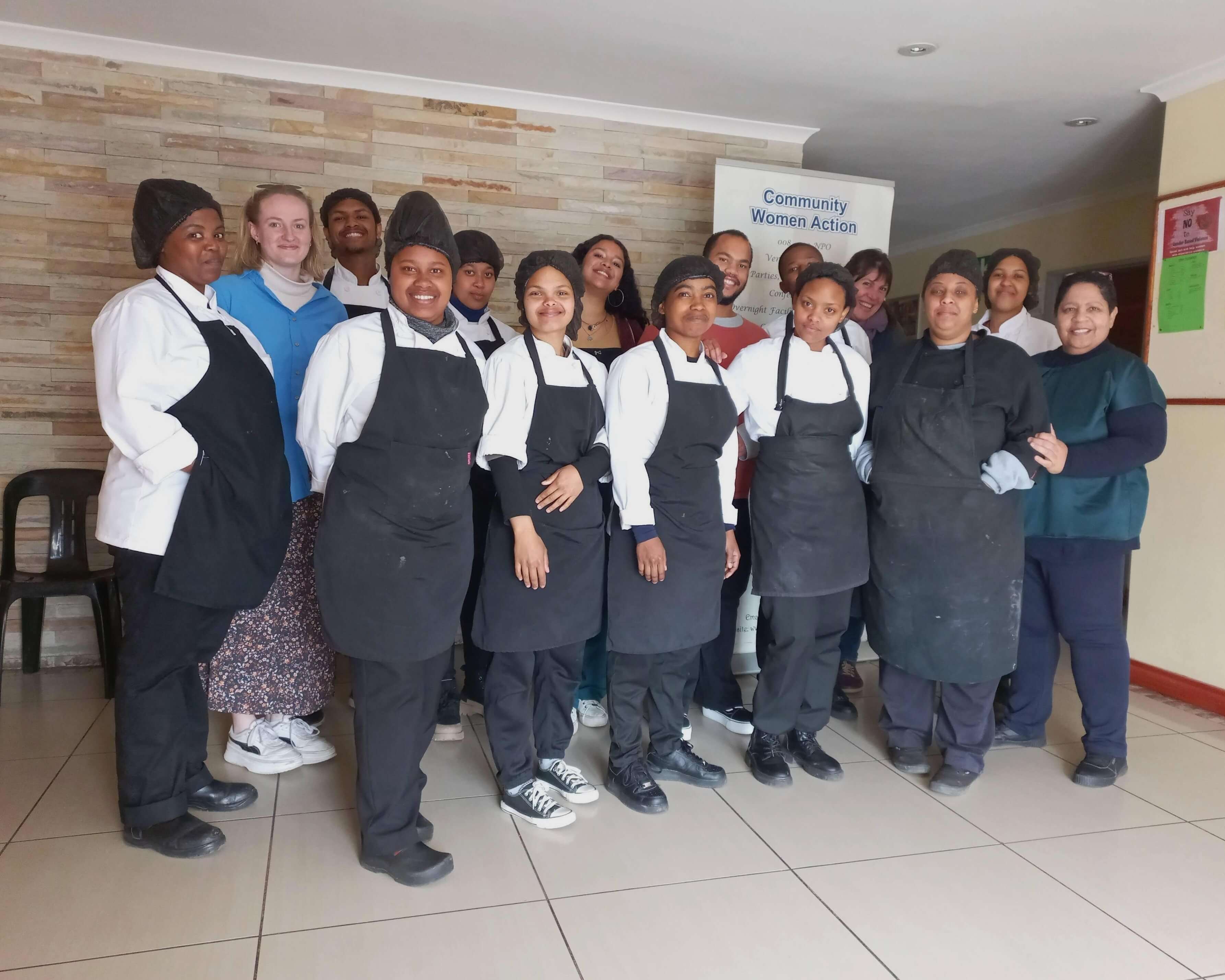 A group of women in chef aprons